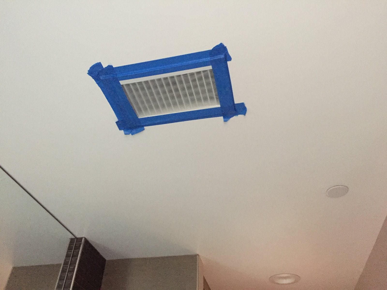 A supply register taped off before a duct leakage test, so the only air escaping is through the leaks.