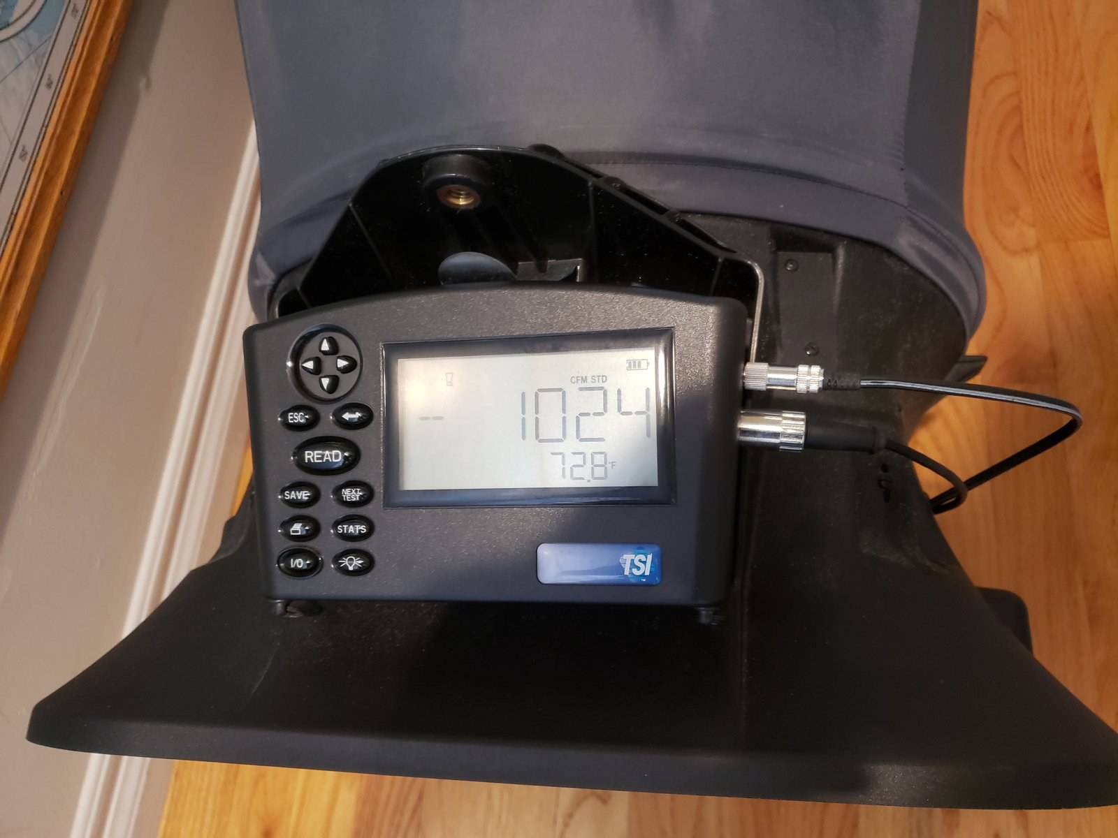 A flow hood reading 102.4 on a supply register, one of the airflow checks behind a CF-3R.